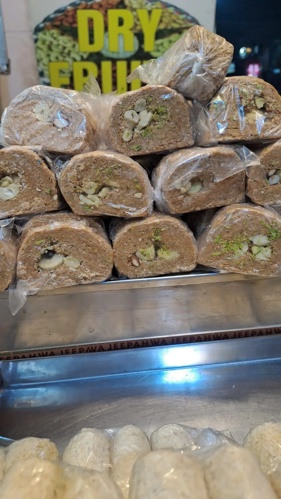 Wrapped gazak rolls stacked with their nut-filled centres facing forward.