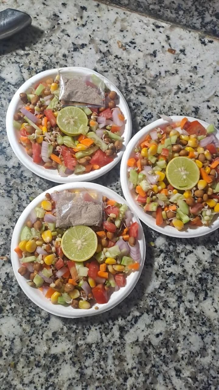 Three bowls of mixed vegetables and pulses topped with lemon.