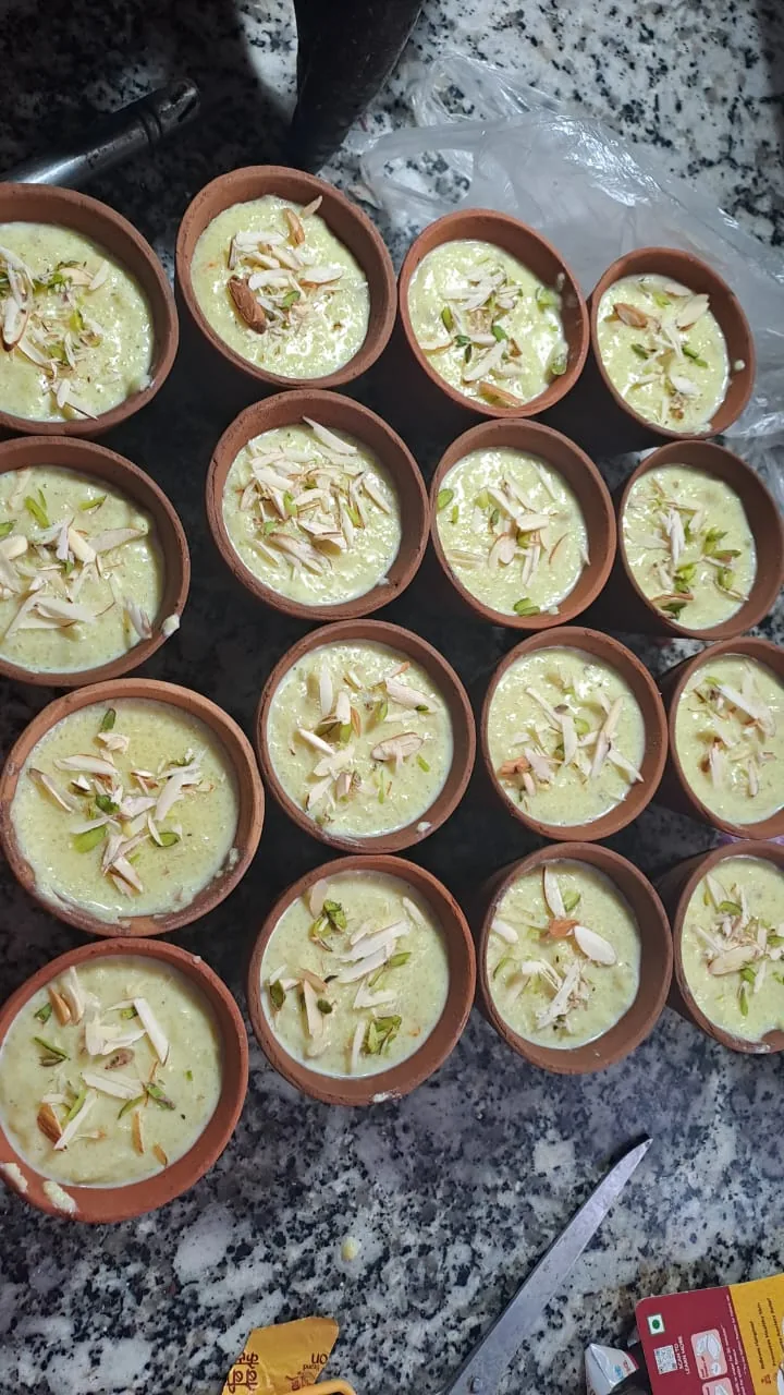 An overhead view of nut-topped desserts in clay cups.