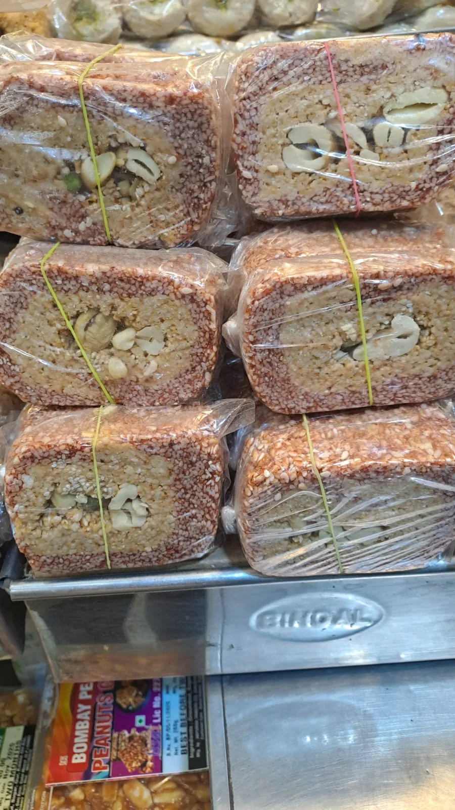 Stacks of wrapped gazak showing a nut-filled centre.
