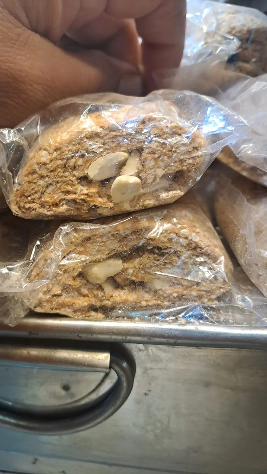 A wrapped gazak roll showing its layers and nut filling.